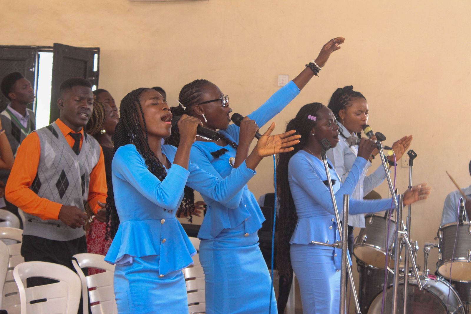 The worship team singing in matching blue outfits