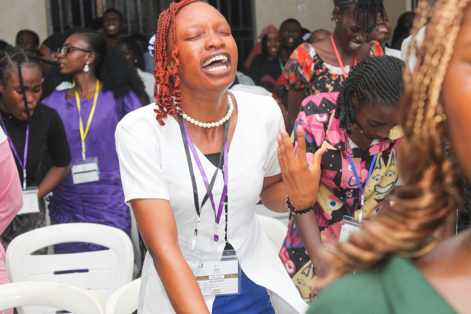 An attendee laughing with joy during worship