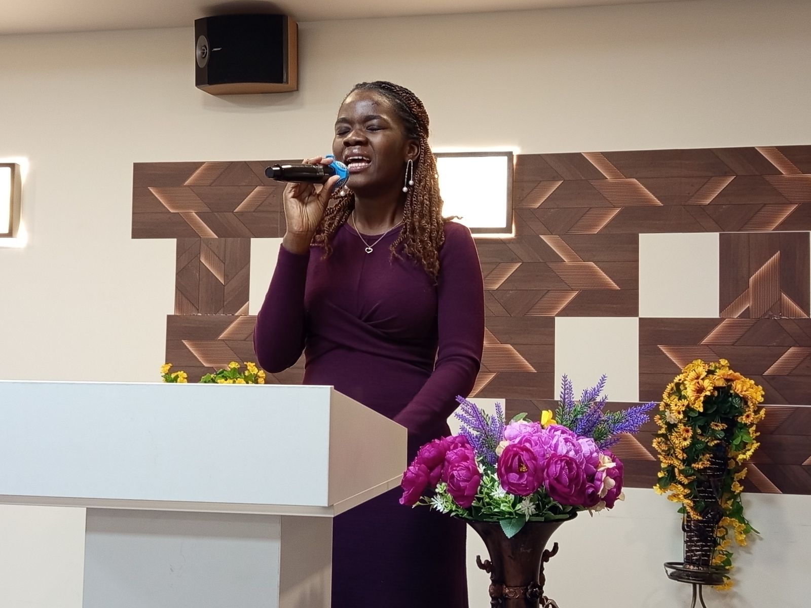 A minister in purple preaching from the pulpit