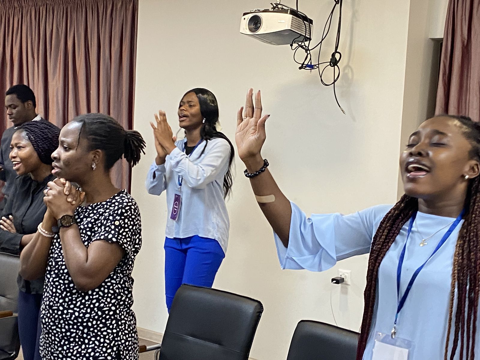 Young women lifting their hands in worship
