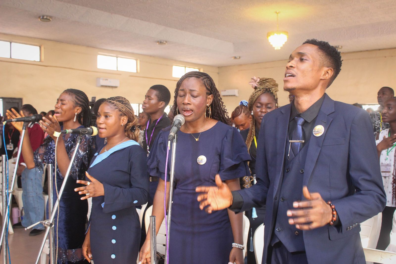 Singers leading worship together at the microphones