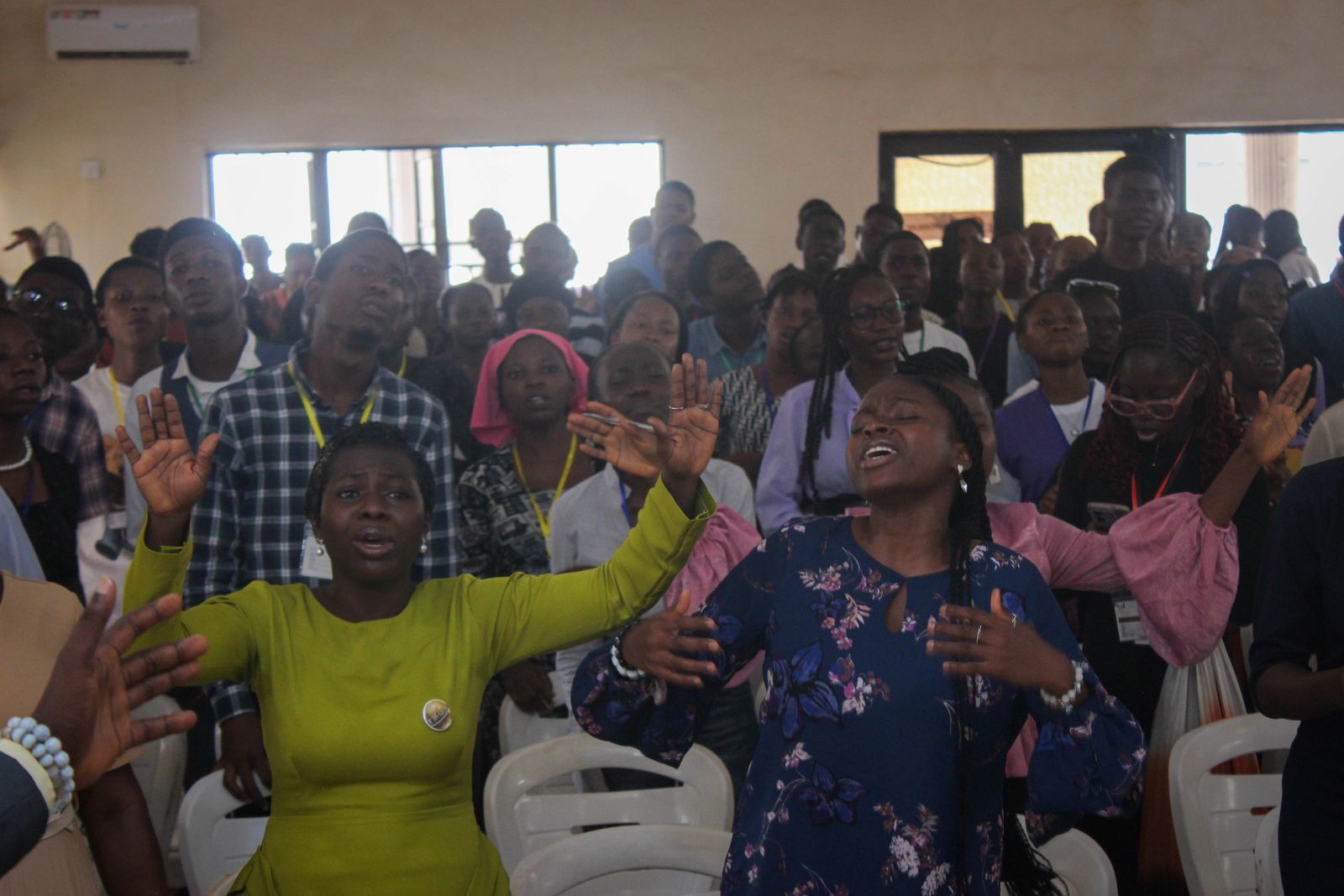 Attendees praying fervently during a prayer session