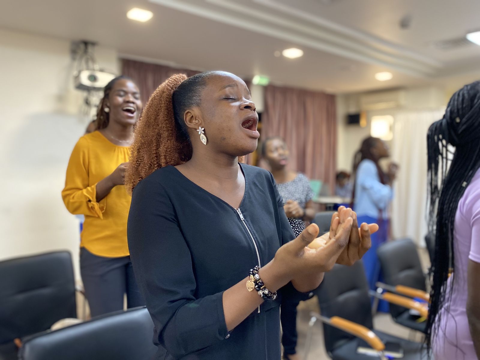 A young woman singing in worship