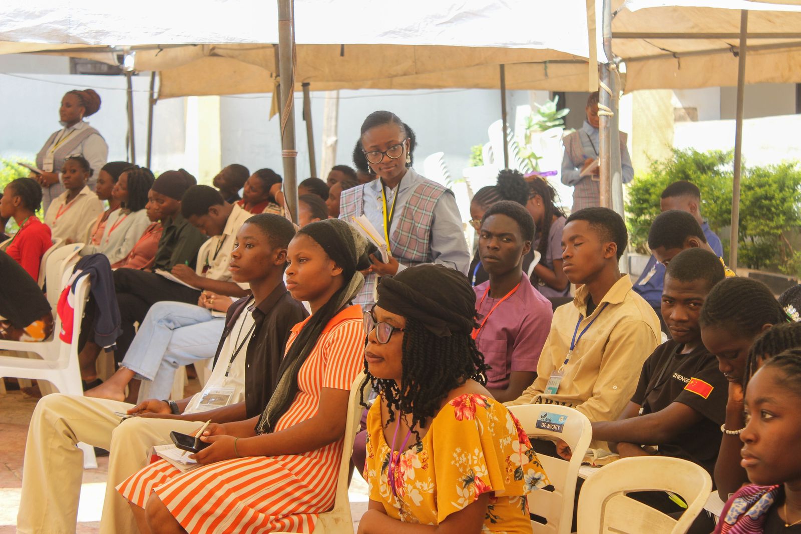 Attendees gathered under the tent outdoors