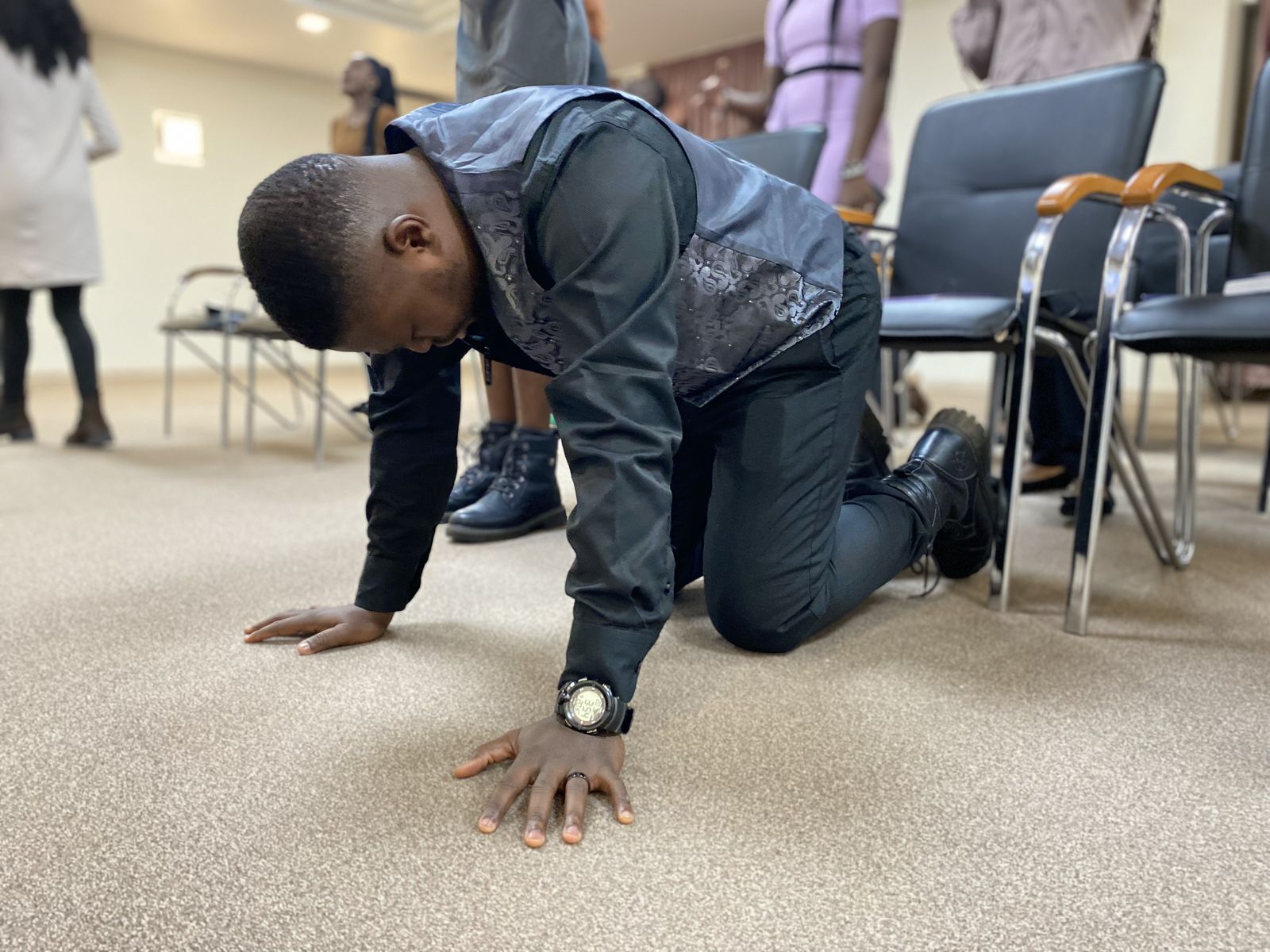 An International Region member kneeling in prayer