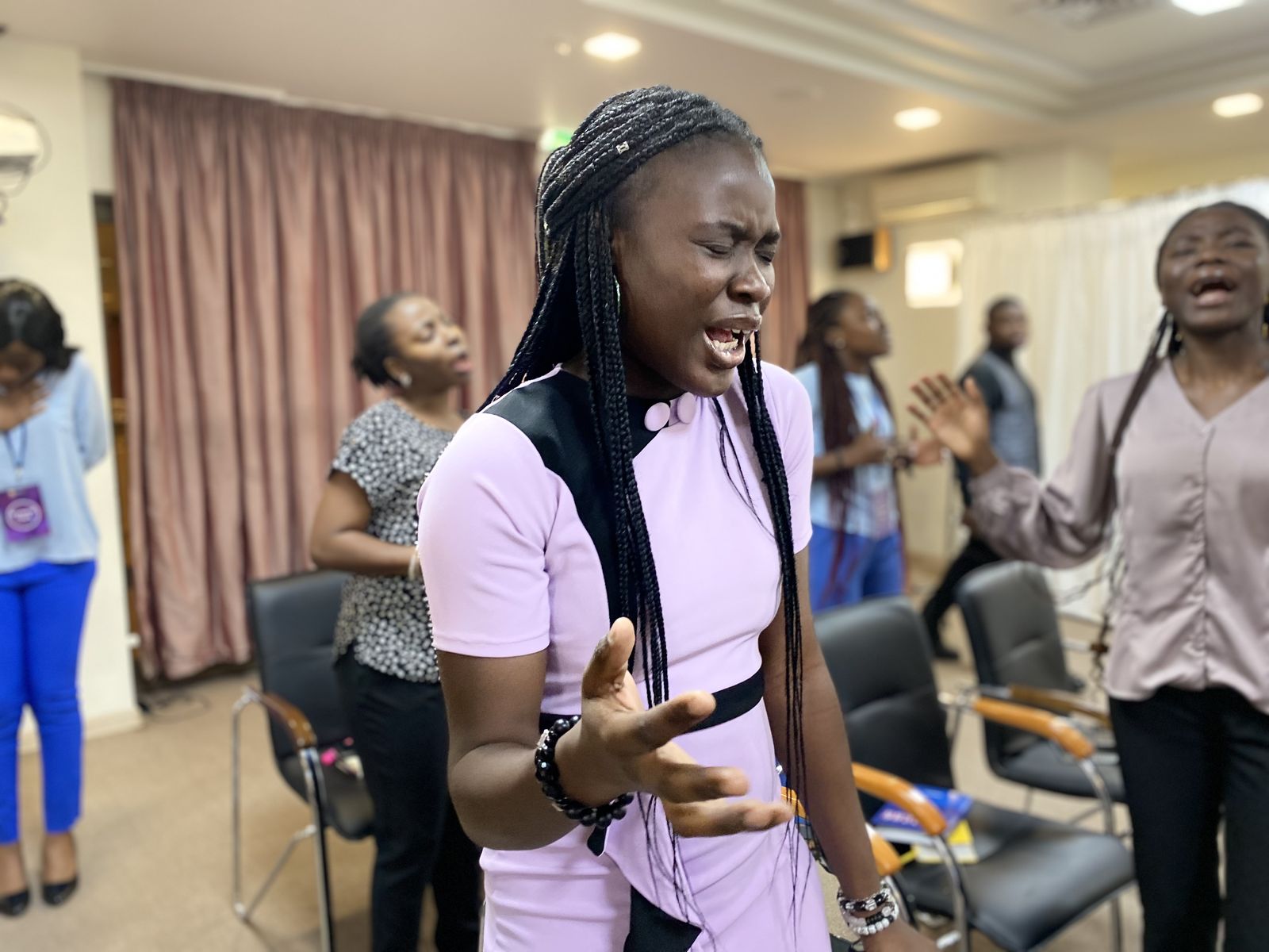 An International Region member praying during a session