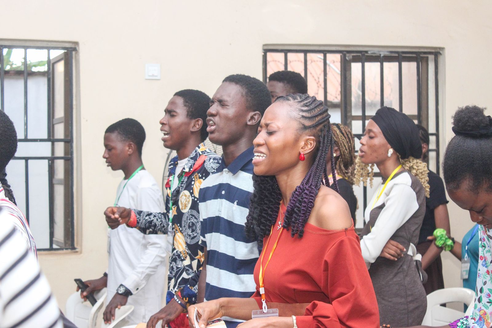A row of young people singing and worshipping together